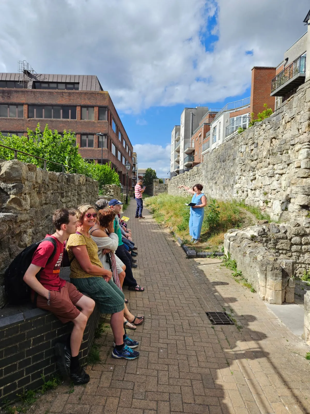 Kay speaking to a walking tour group beside Southampton's walls