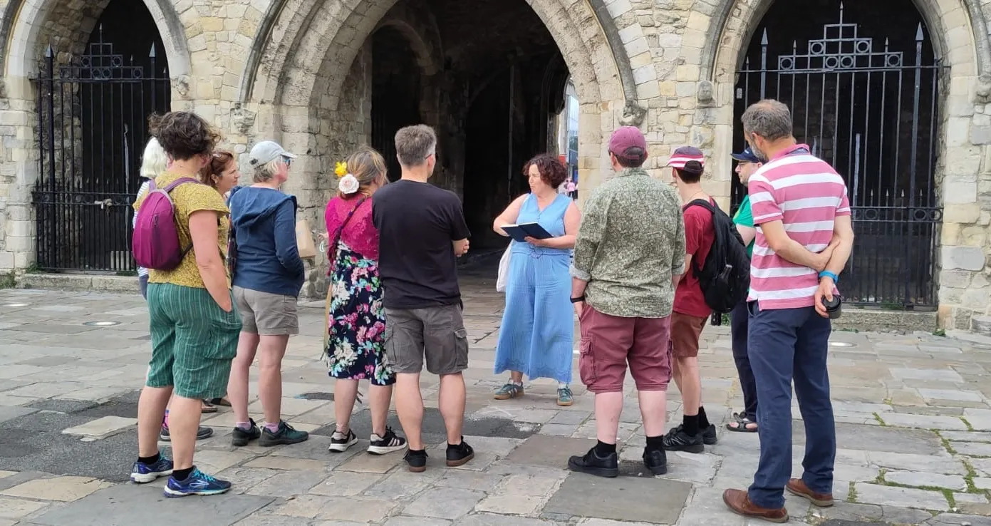 Kay leading a walking tour outside the Bargate in Southampton
