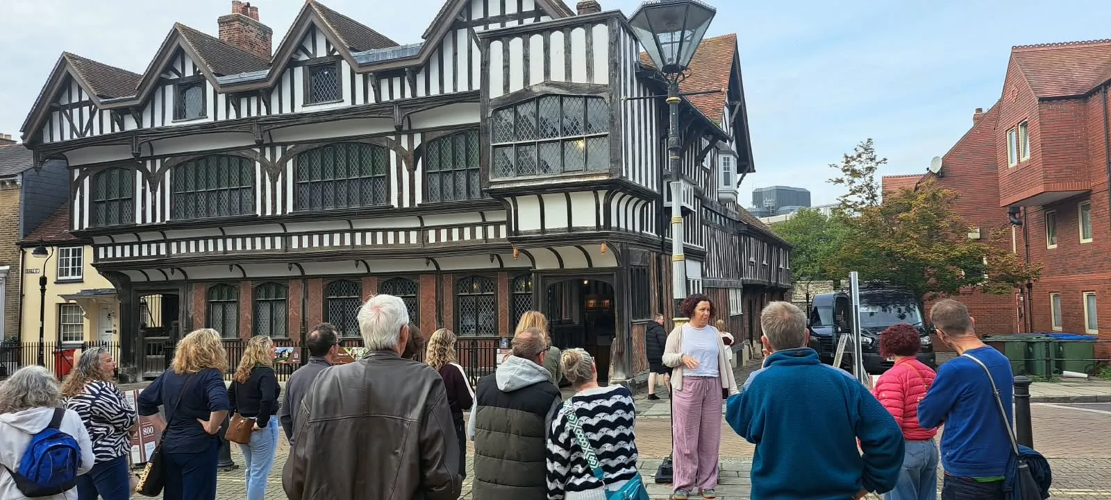Kay leading a tour group outside Tudor House